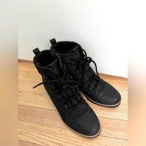 Tie up black boots with tan line trim